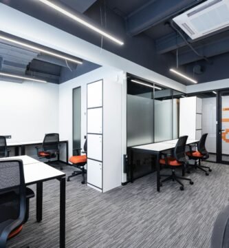 Spacious and modern office interior with sleek furniture and bright lighting.
